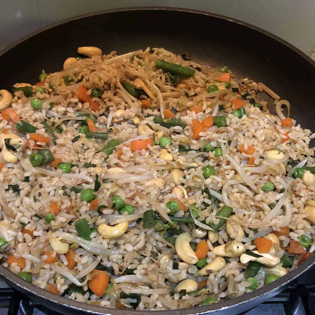 Vegan fried rice in a black pan.
